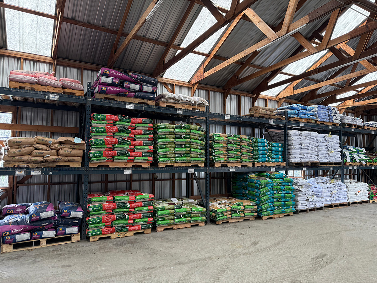 corrugated-metal warehouse filled with 50-pound bags of feed